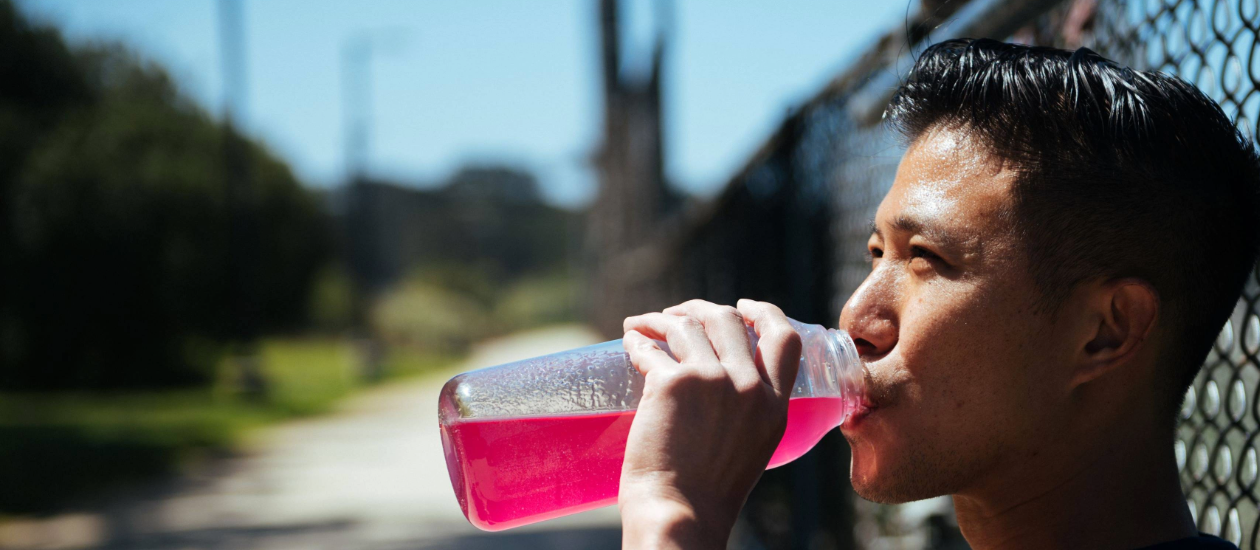 man drinking pink GU Hydration Tabs