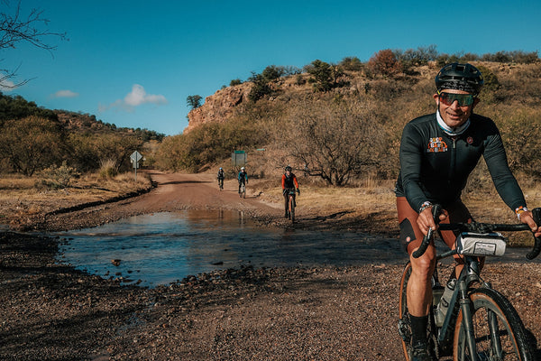 Gravel rider riding through a creek