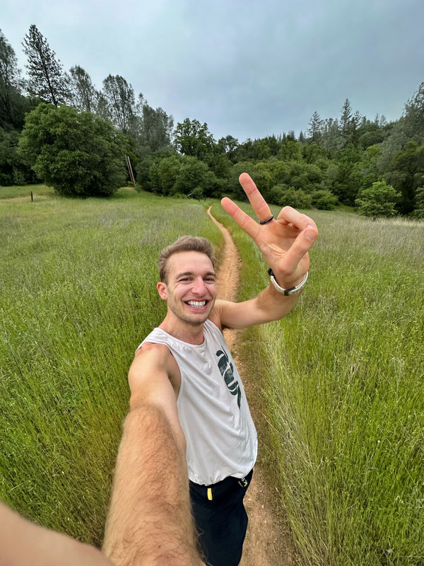 Runner on trail giving peace sign