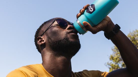 man drinking out of a GU Bivo bottle