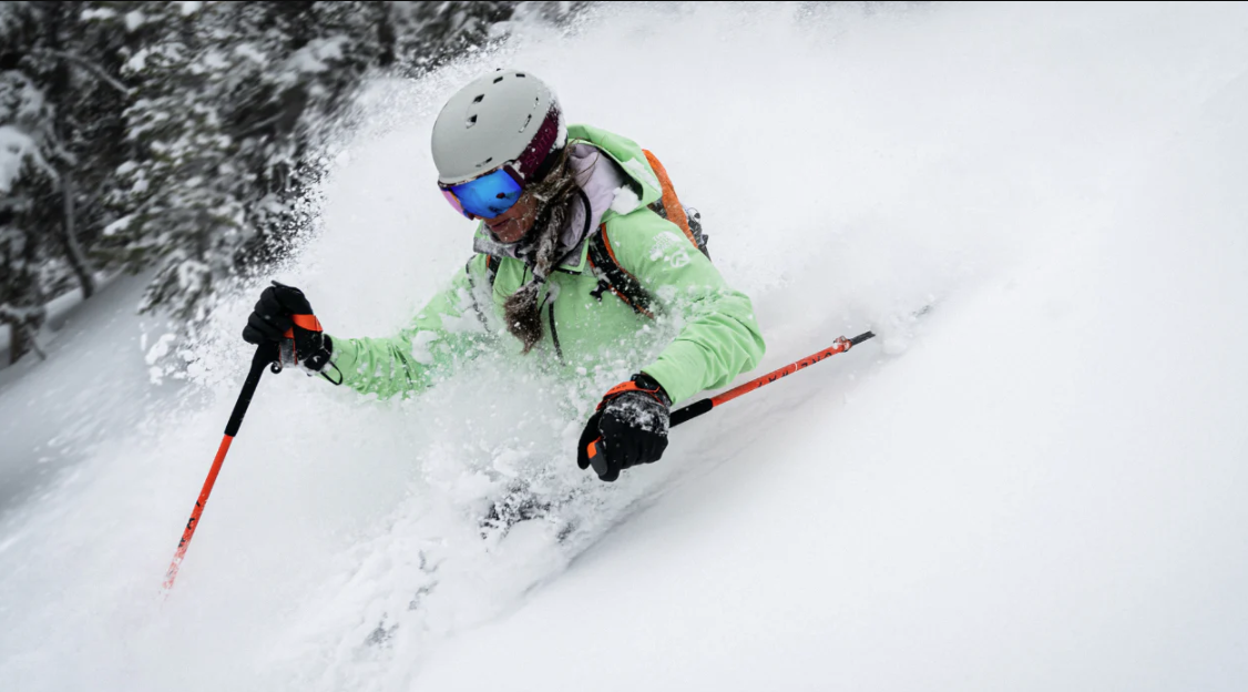 person skiing down the mountain in deep snow